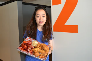 woman holding tray of food
