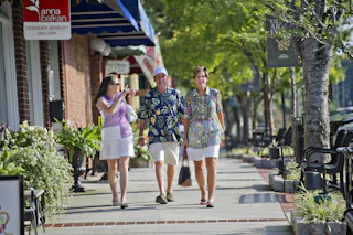 people walking down sidewalk