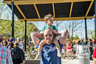 boy on man's shoulders