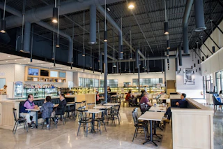 people at tables in a bakery