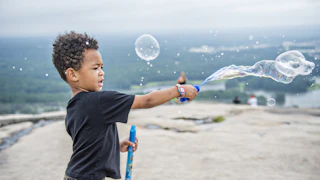 Kid playing with bubbles