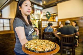 woman holding dish of food
