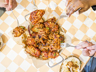 plate of food on a table being shared by several people