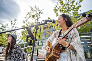 two women on stage
performing at a concert